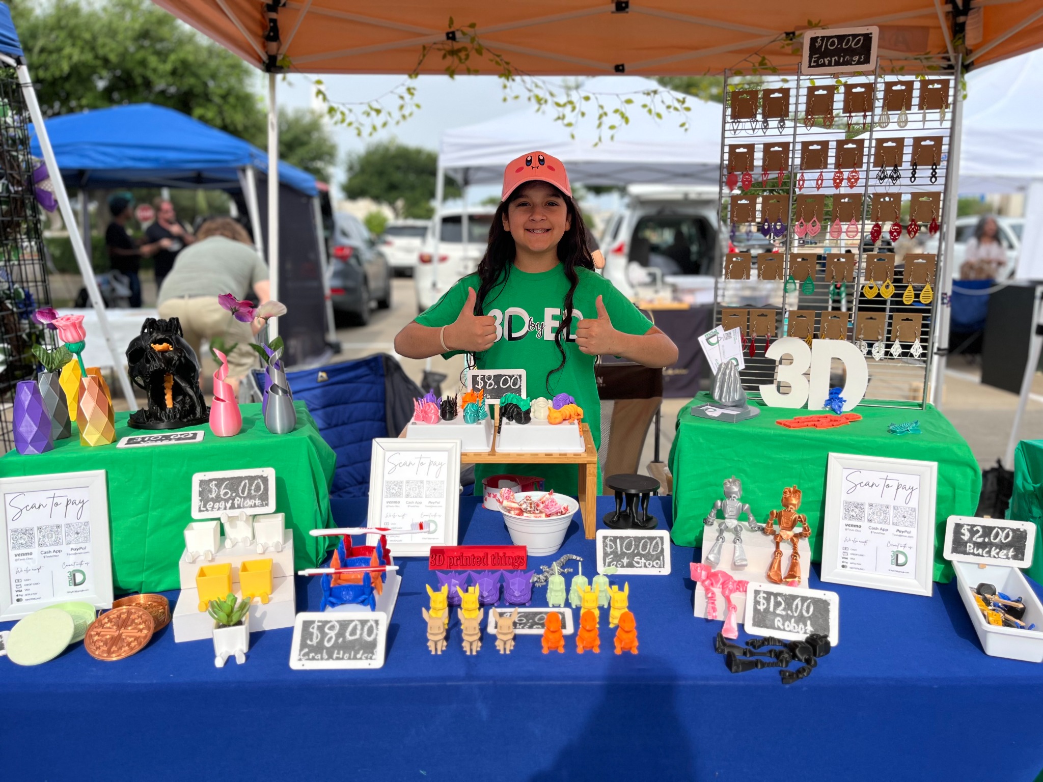 Young entrepreneur selling 3D-printed products at a market